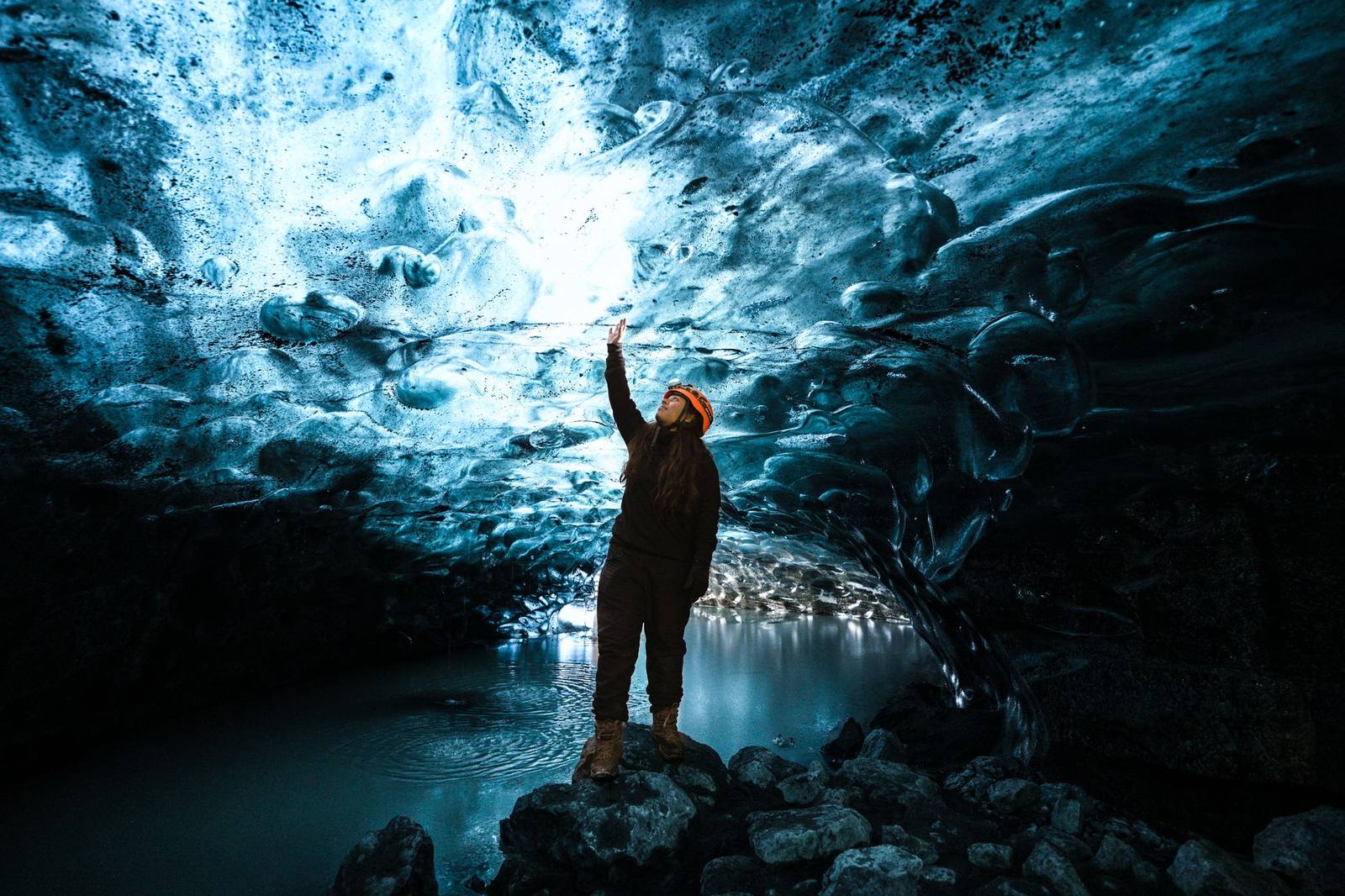 A guest inside a blue ice cave