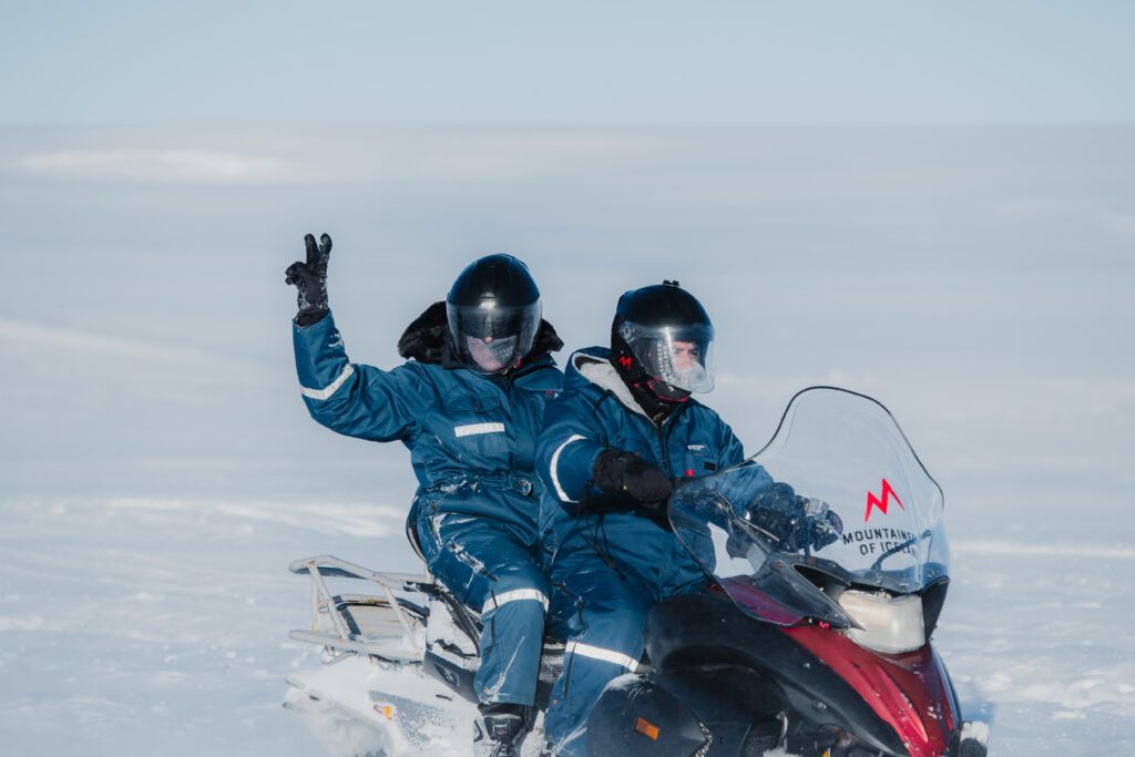 A group snowmobiling on a glacier in Iceland